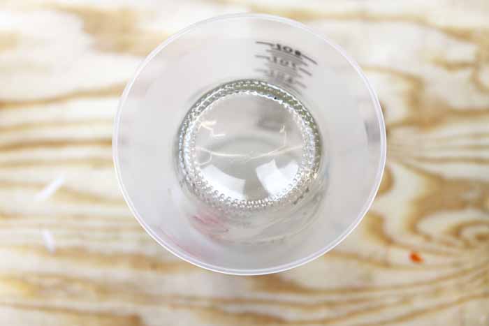 Upside down mason jar inside of a mixing cup