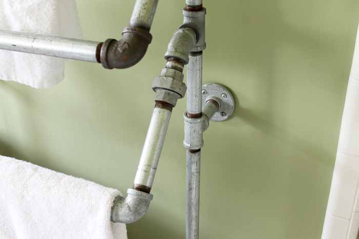 This rustic towel rack is made with galvanized pipe pieces!