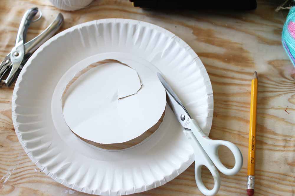 Cut out the center of the paper plate with a scissors