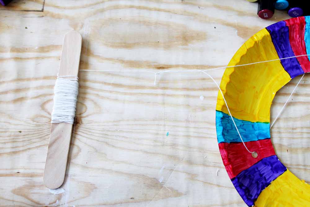 Create an anchor for your kite by wrapping a long piece of kite string around a Popsicle stick