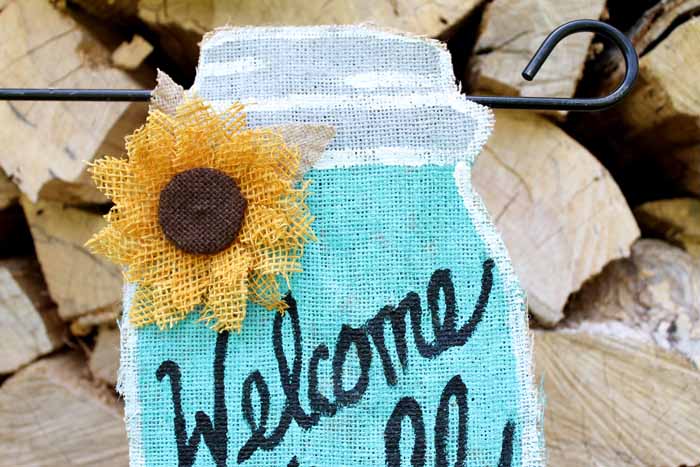 blue mason jar shaped garden flag with sunflower