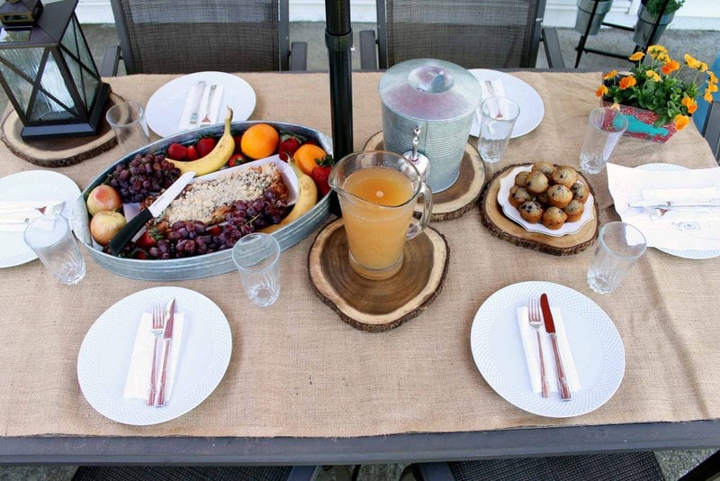 patio table covered in burlap with brunch items