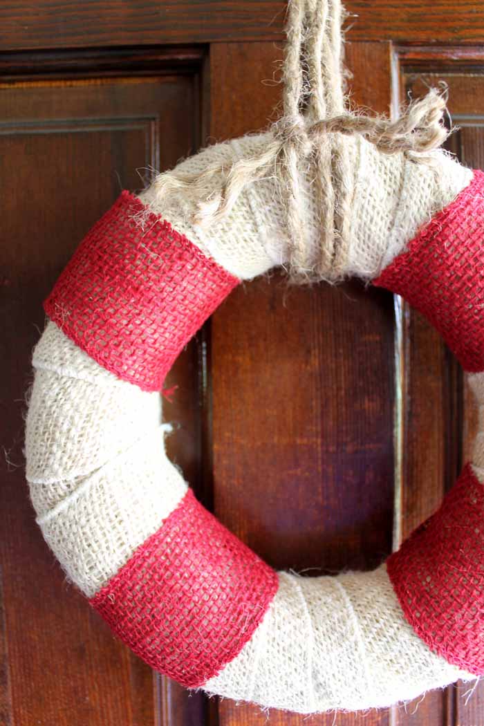 Make this DIY burlap wreath that looks like a life preserver! Perfect for summer and beach themed decor!