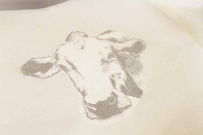 Make this farmhouse pillow for your home in a few simple steps! You will love the cow silhouette!