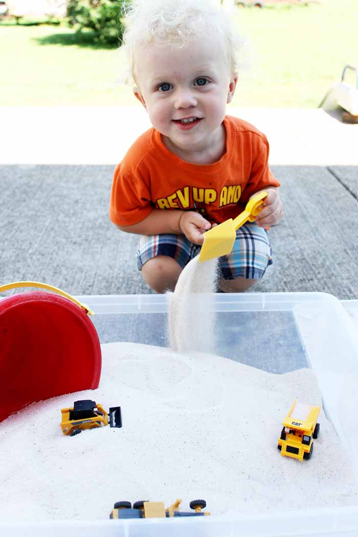 front view of boy and sandbox