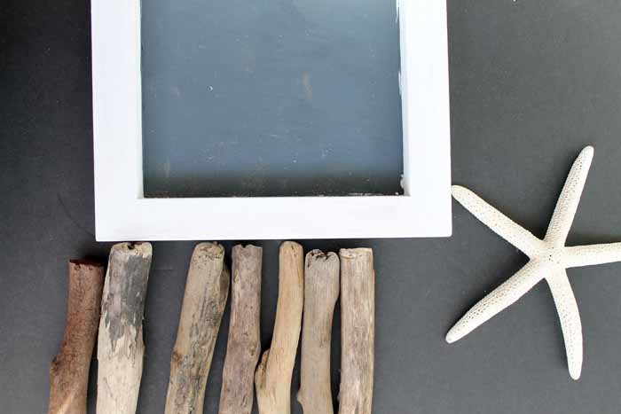 frame with driftwood pieces and star fish