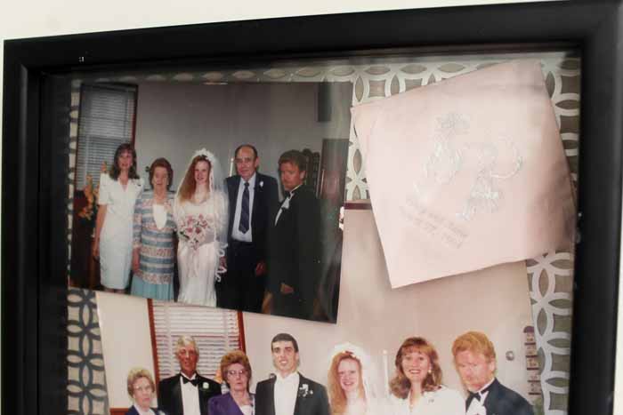 wedding mementos displayed in a glass front box.