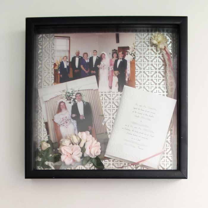 a fillable picture frame with wedding photos and invitation inside