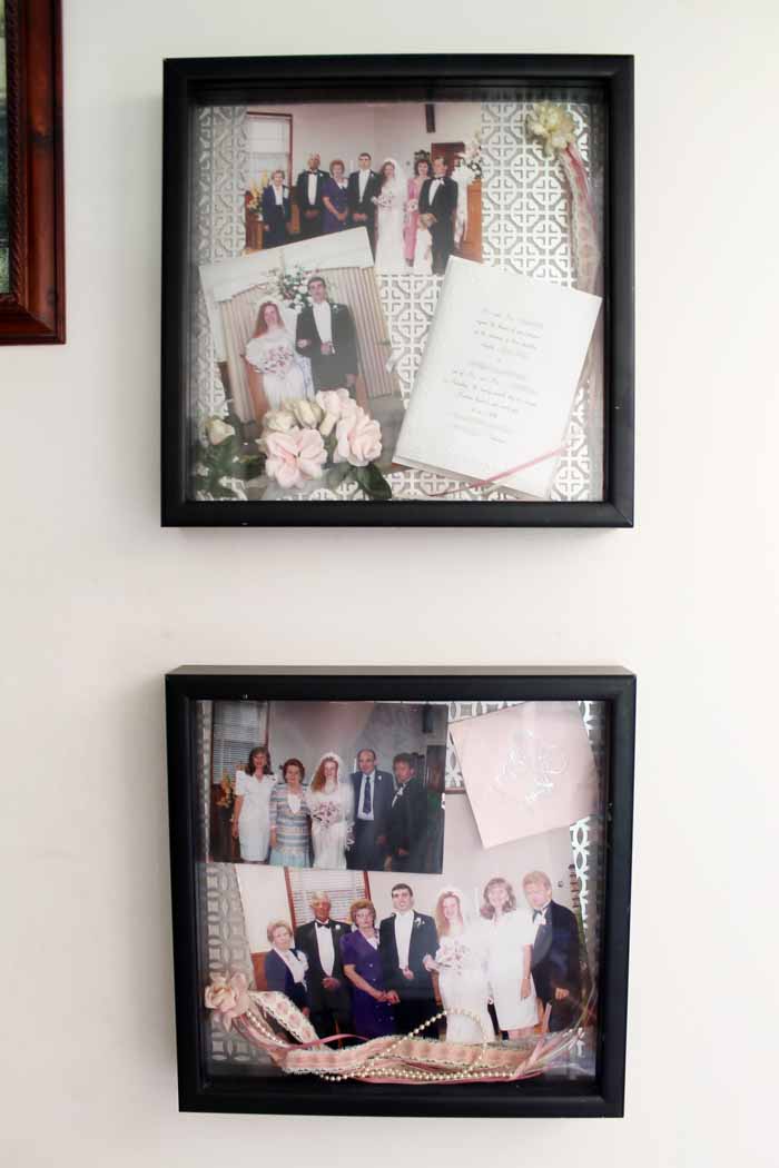 Wedding shadow boxes filled with memories and hung on a white wall