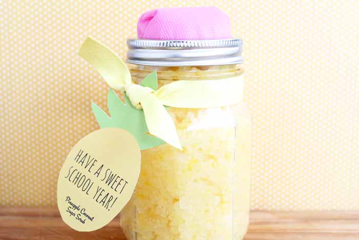 Teacher gift that is a mason jar shaped like a pencil and filled with yellow sugar scrub