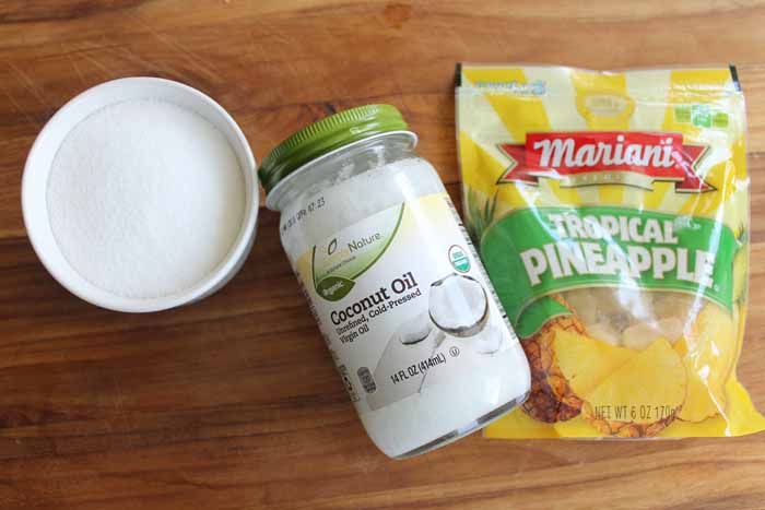 coconut oil and pineapple on wooden backdrop