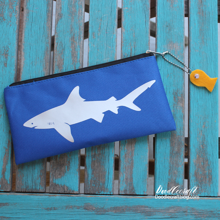 blue pencil case with image of shark on top