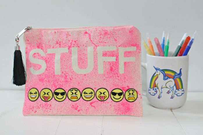 pink dyed with emojis stamped across with unicorn cup of pencils 