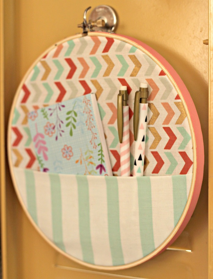 embroidery hoop framed fabric that has pens and stationary