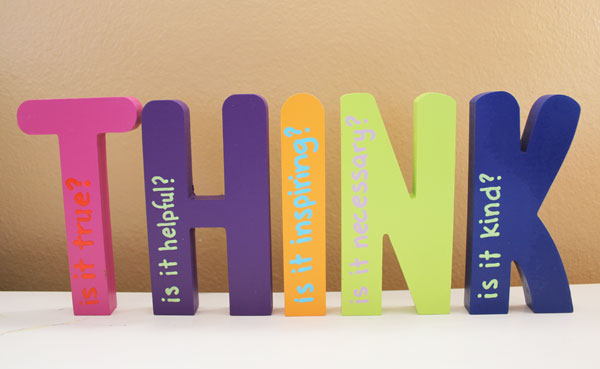 h i n letters in front of wood backdrop