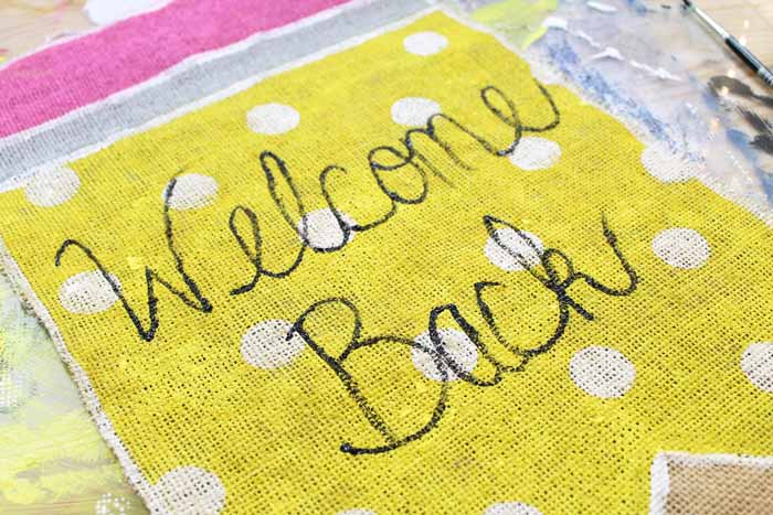 welcome back written on yellow burlap pencil