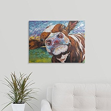 painting of a cow on white wall with white couch and plant