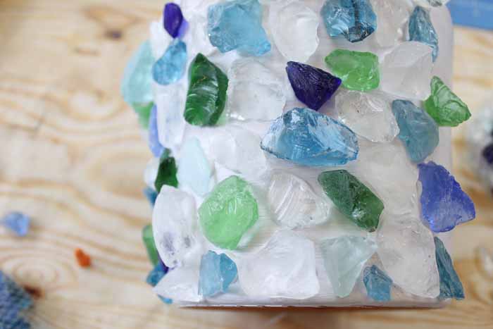 Overhead view of sea glass glued onto a white painted planter