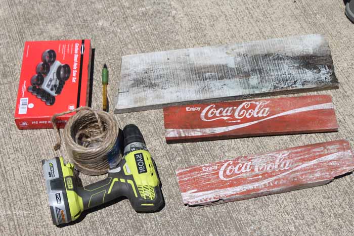 supplies on the driveway to make a vintage coca cola tray