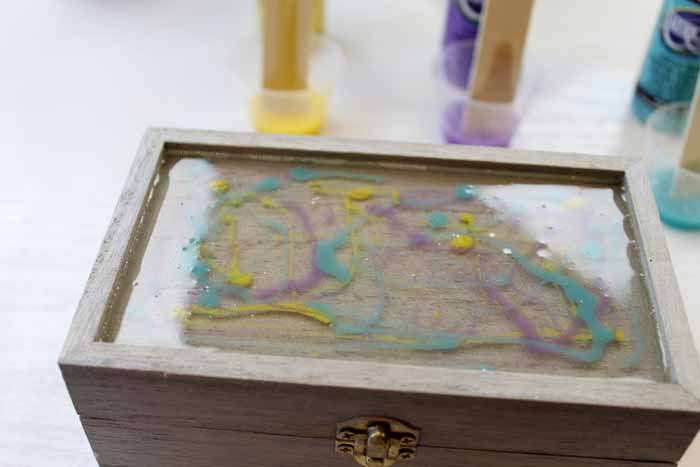 scattered acrylic paint on the top of a jewelry box