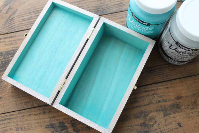 painting inside of a jewelry box turquoise on a wooden backdrop