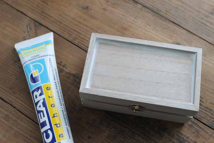 picture of unfinished wood jewelry box and clear adhesive