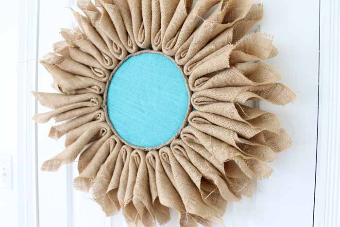 Learn how to make burlap flowers! A simple project that will look great as a wreath or in your home decor!