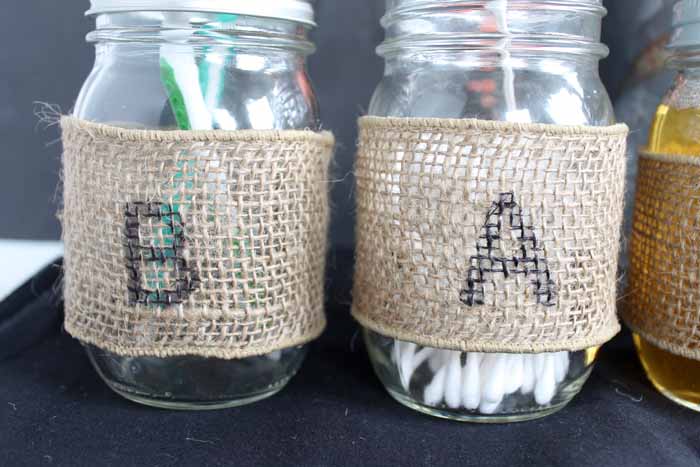 Decorated mason jars to organize bathroom supplies