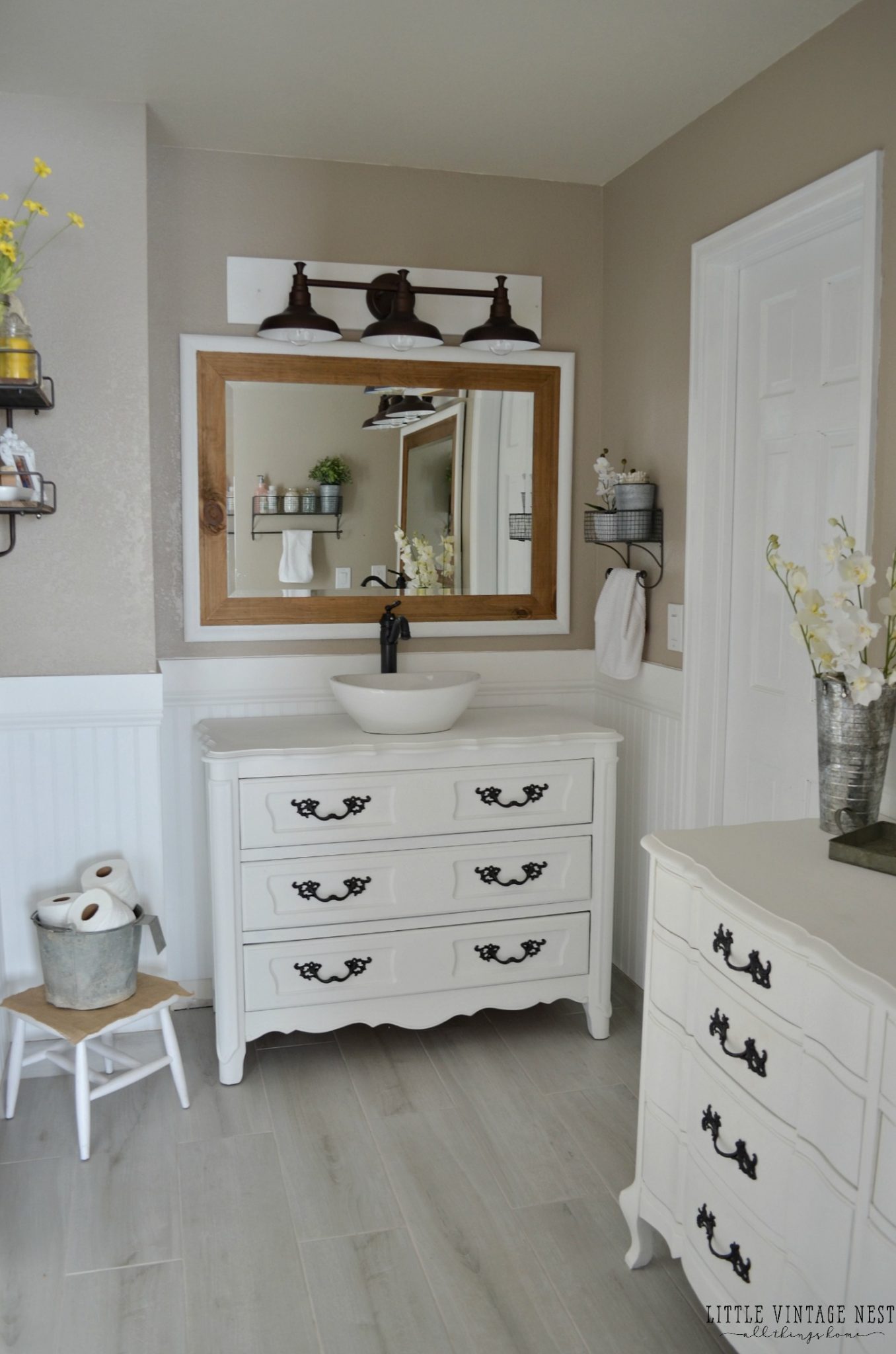 Using furniture, like a dresser, as a bathroom vanity is a rustic bathroom decor idea that is perfect for farmhouse style