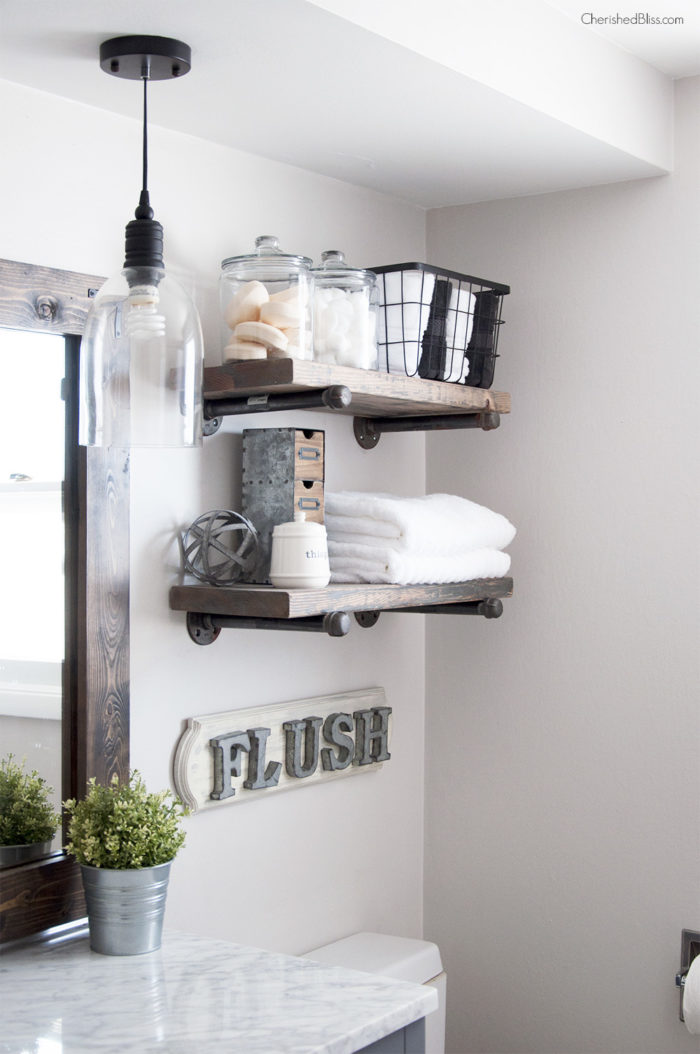 A rustic wood and pipe shelf is an easy way to add storage and rustic style to your bathroom