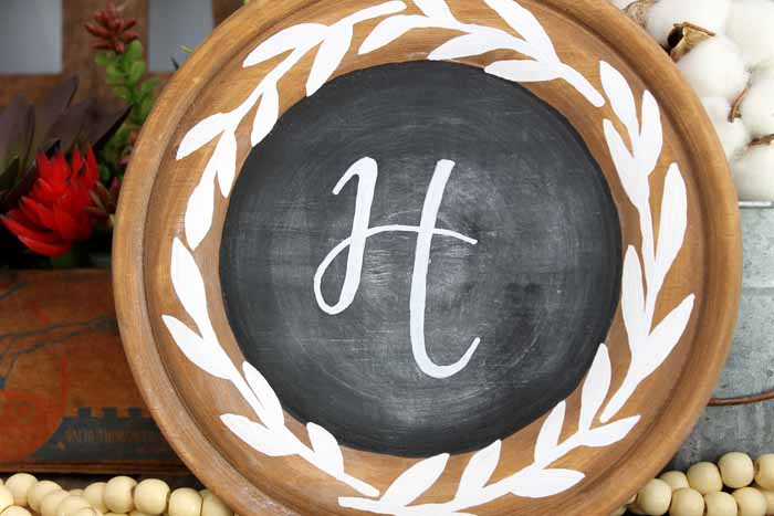 close up of a rustic chalkboard with a white painted wreath