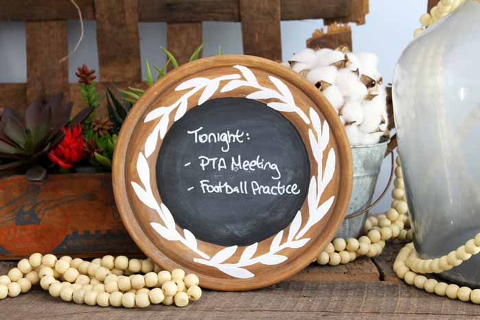 rustic chalkboard in a vignette with a tobacco basket, cotton and wooden beads