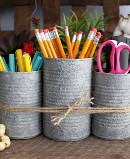 trio of cans tied with jute to organized school supplies