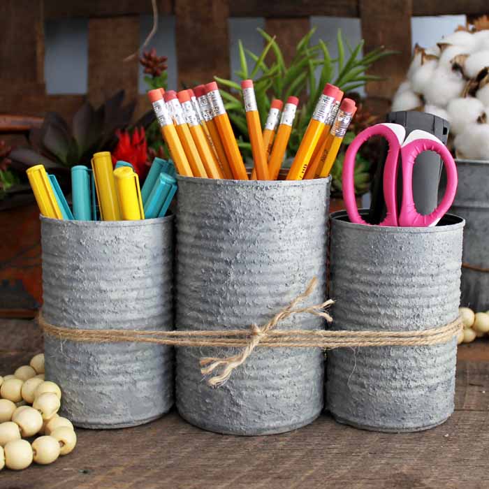 trio of cans tied with jute to organized school supplies