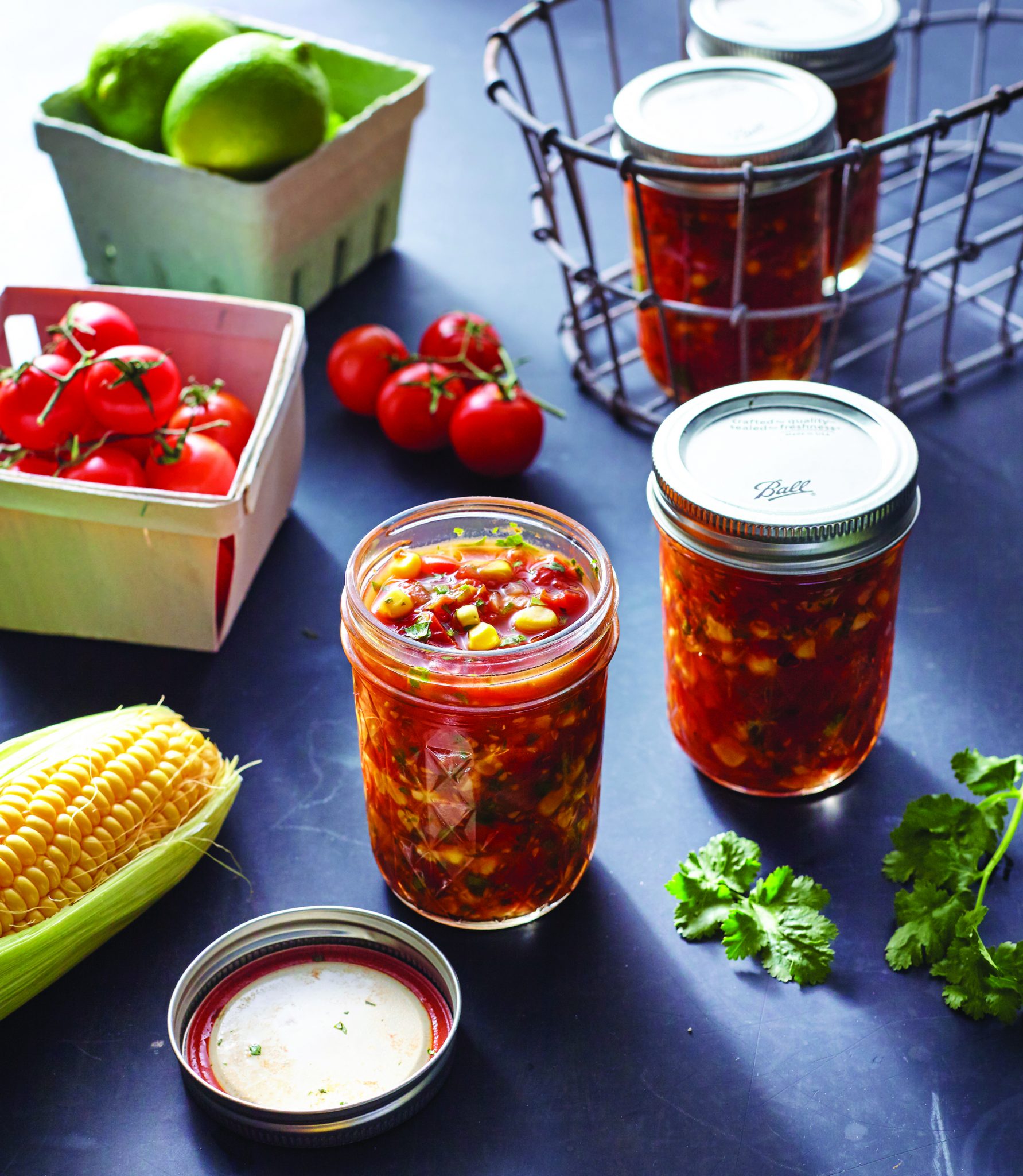 Ingredients and jarred corn cherry tomato salsa in a mason jar