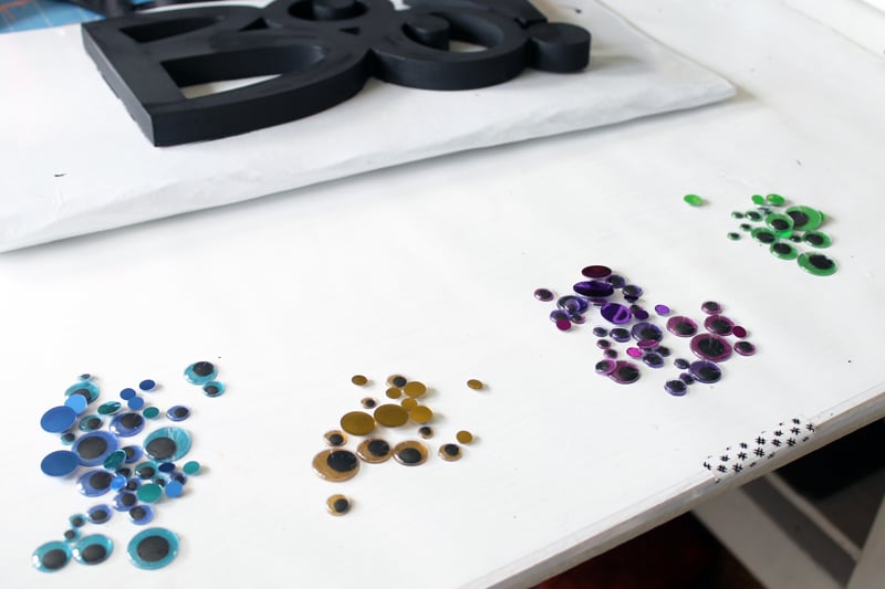 groupings of colorful googly eyes on a white table