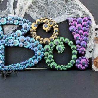 Make this boo sign for Halloween! You will love this sign made from google eyes!