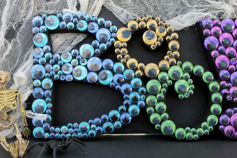 Close up of Colorful Boo Halloween letters on a black backdrop