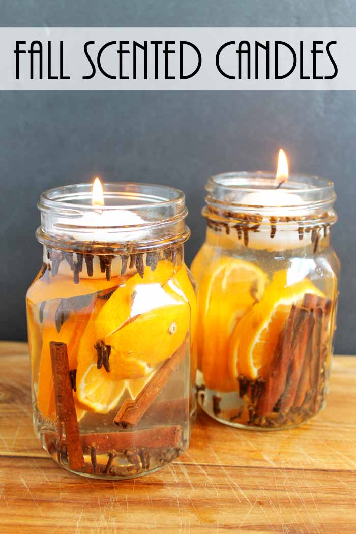 two glass jar candles with citrus and spices