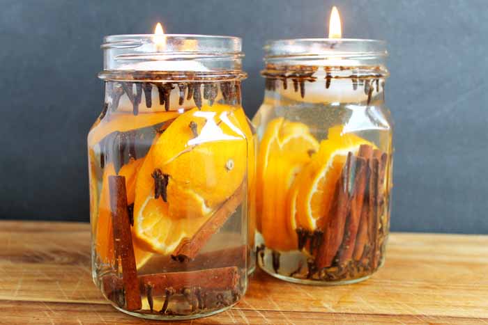 two glass jar candles with tea lights