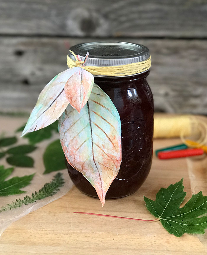 Mason Jar with printable leaf gift tags on a light wood table