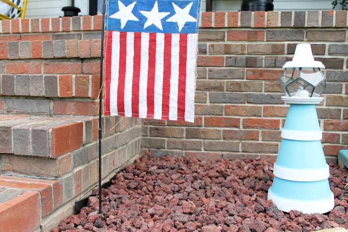 Flower pot lighthouse with American flag