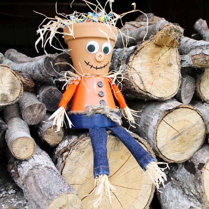 This clay pot scarecrow makes a perfect Halloween candy bowl