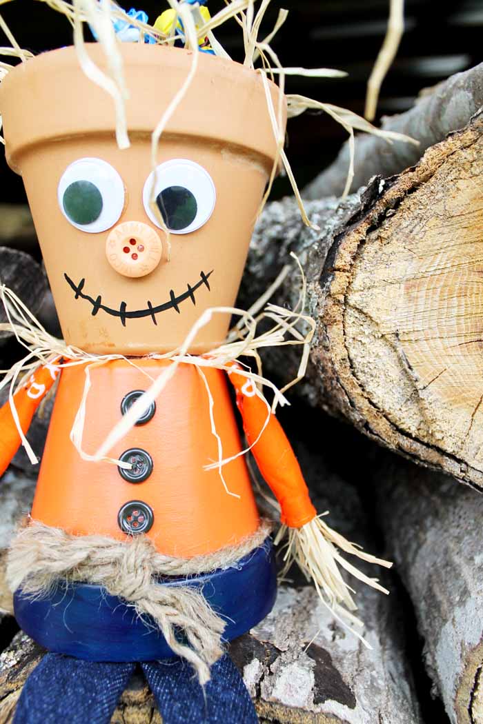 Make this adorable clay pot scarecrow that doubles as a trick or treating candy bowl