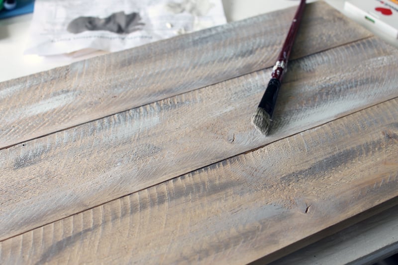 adding a layer of white paint using a barnwood painting technique