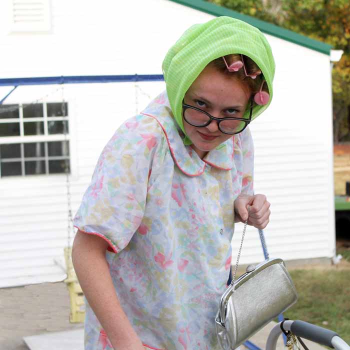 A person wearing and old lady halloween costume