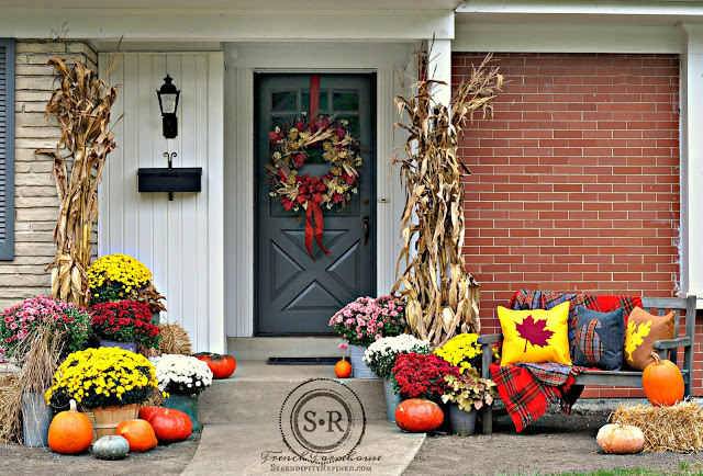 fall porch decor with pumpkins, mums, a wreath and bright colors