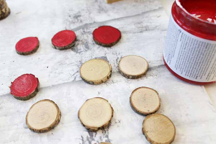 Stain the wood slices to use as the game pieces on your outdoor game board