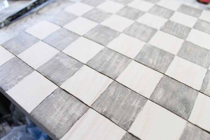 Use the wood burning tool to create lines on your outdoor checkers game board