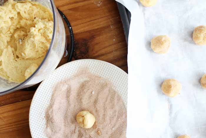 A plate of food on a table, with Snickerdoodles dipped in sugar